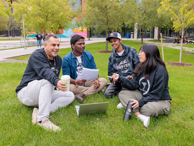Group of CU Denver students sitting in grass