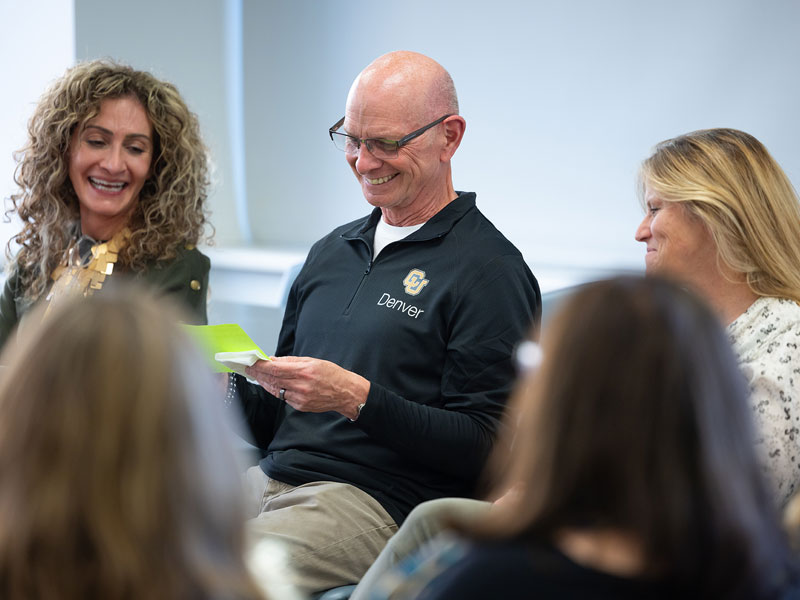 Group of Change Maker students and CU Denver faculty sitting together in an open house