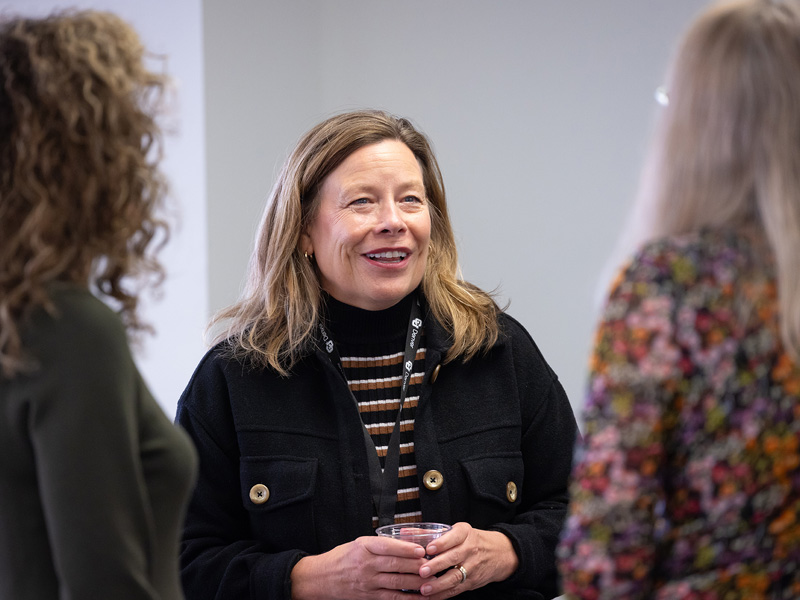 Three CU Denver change maker students standing around talking to one another