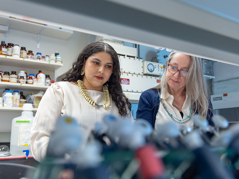 CU Denver student working in biology lab with faculty member