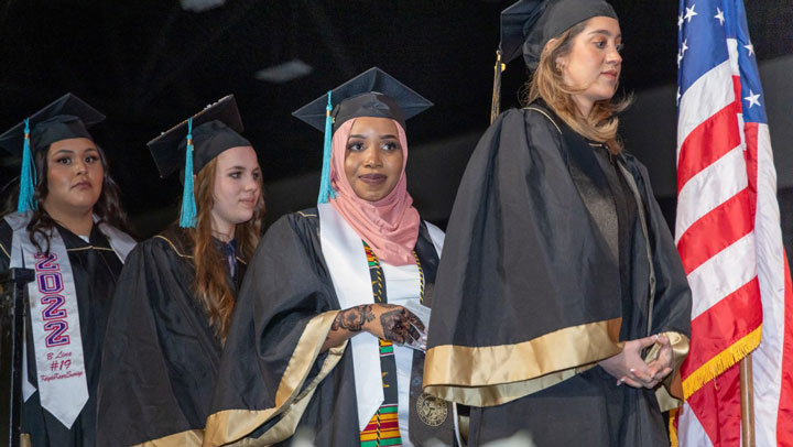 CU Denver graduates walking across the stage at commencement