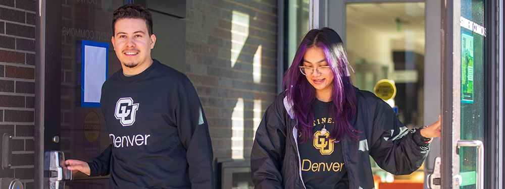 CU Denver graduate students with Lynx spirit wear on campus