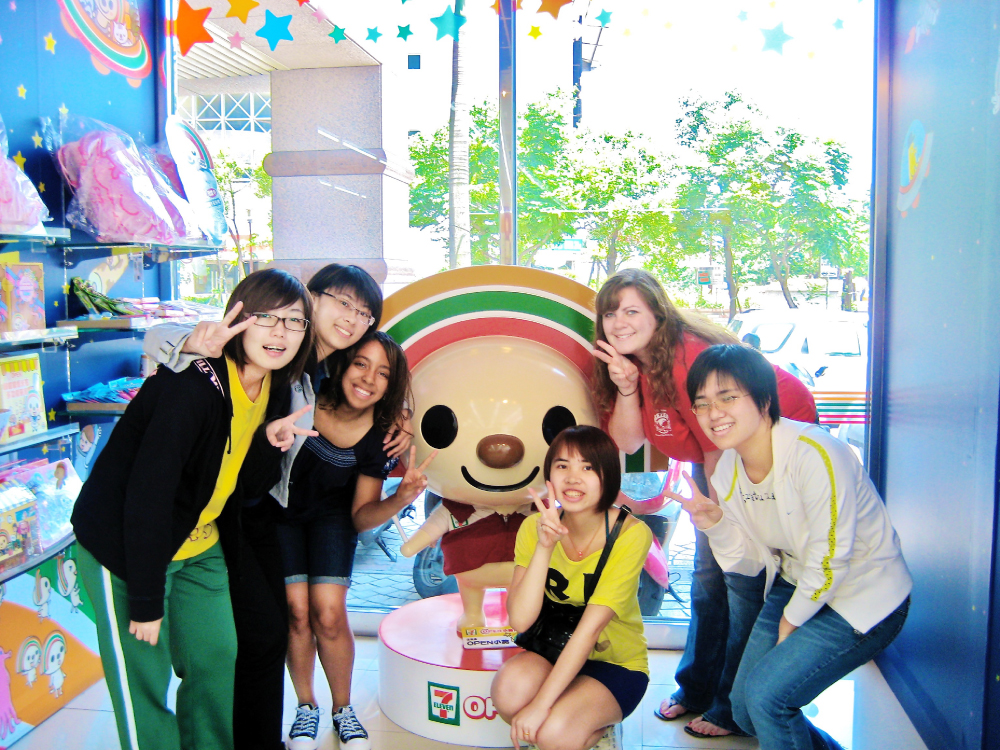 Krystal Booker-Reusch taking a photo with other students inside of a Taiwanese 7-11