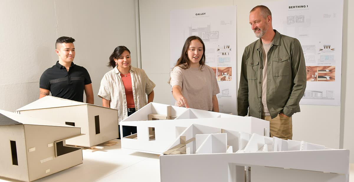 Architecture students around models.