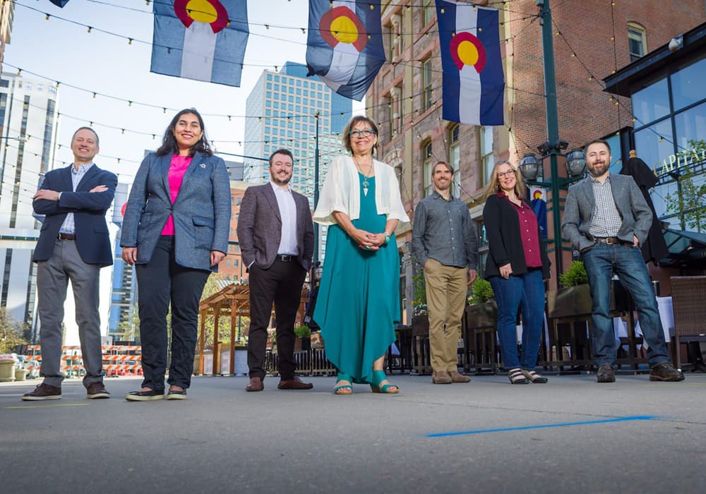 Seven faculty members standing Larimer Square