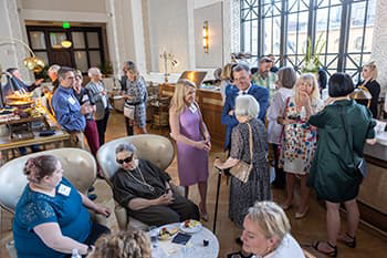 Group of attendees mingling at Cooper Lounge for the Dana Crawford Preservation Program Naming Celebration in May 2022.