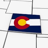 Colorado colored with state flag sitting in a black and white map.