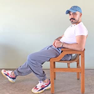 Al Alnajjar sitting in a chair