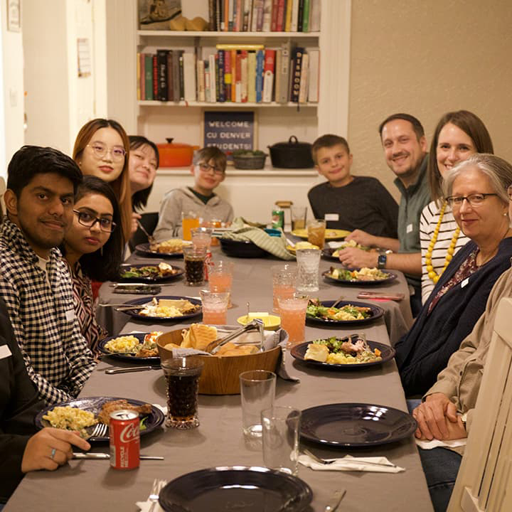 Group of people at a table eating a meal.