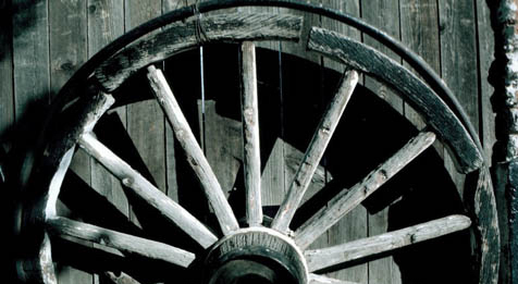 Wooden wheel against a wall