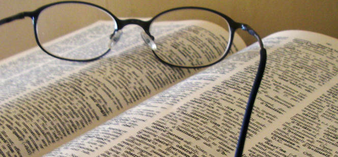 reading glasses resting on an open book