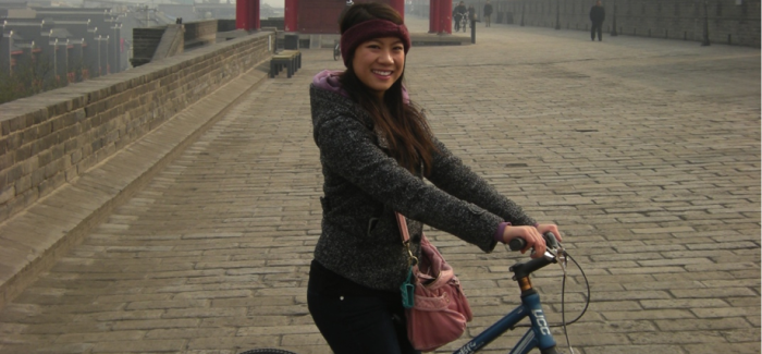 Nancy Tran riding a bike in China