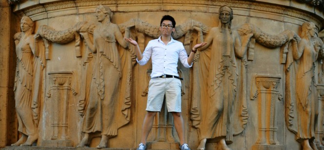 Daniel Edgarth posing in front of stone relief sculpture