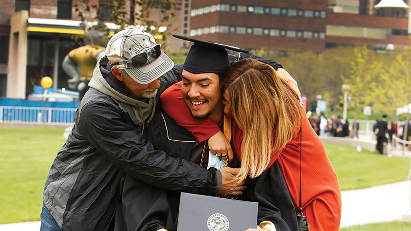 Parents hugging graduate