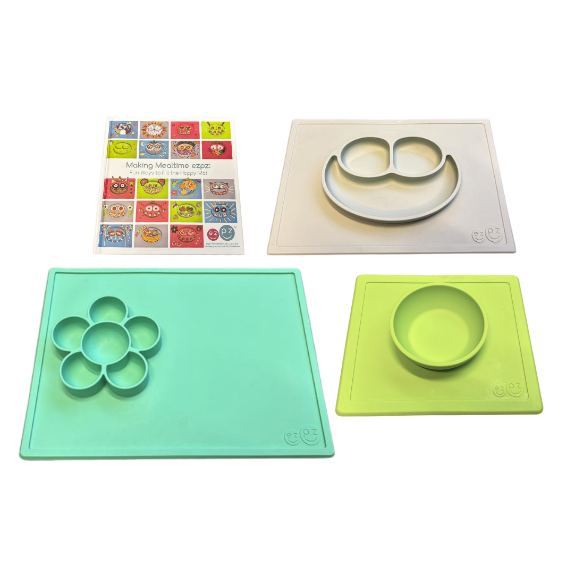 set with three rubber surfaces with raised designs; the raised designs include a smiley face, a flower, and a circle. the set also includes an instruction book