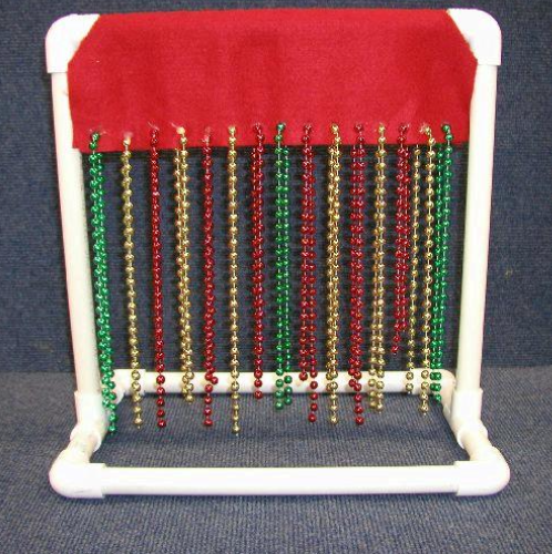 pvc tubes set up to stand with beads hanging from the top