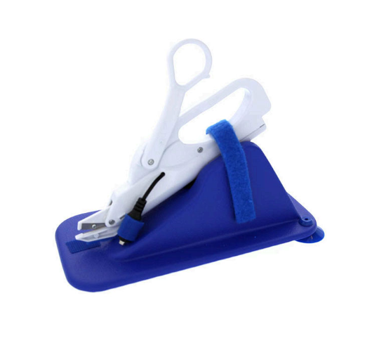 adapted scissors mounted on a slanted piece of plastic