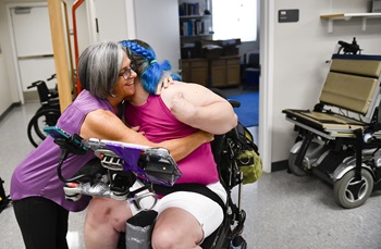 a client hugs her physical therapist 