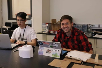 graduate students wok on their laptops