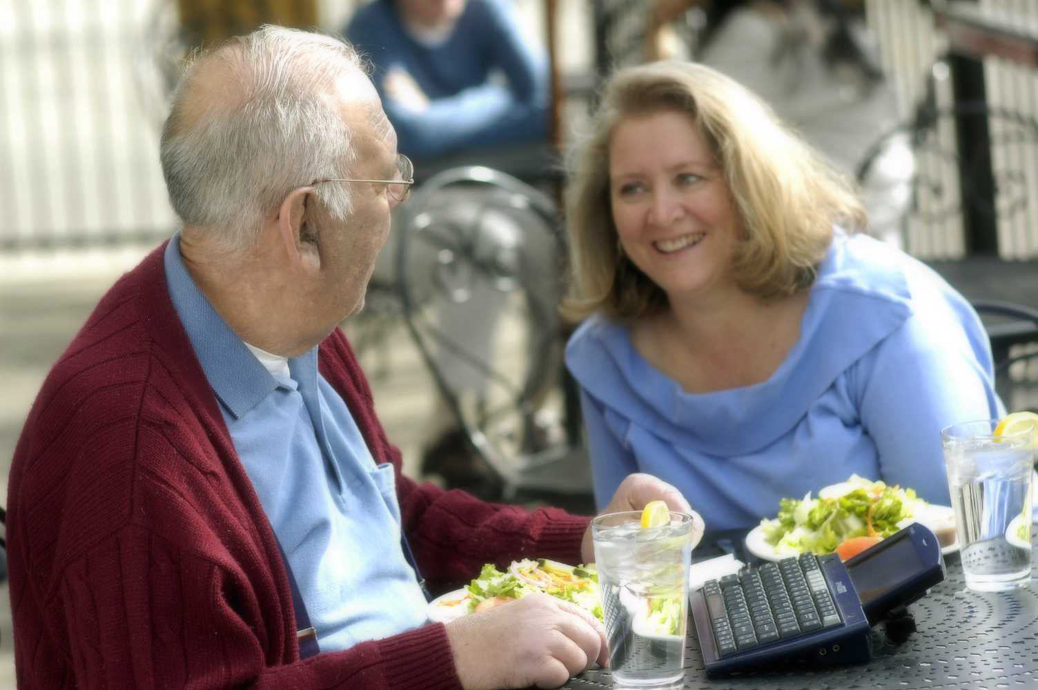 Woman and Man with communication device having lunch