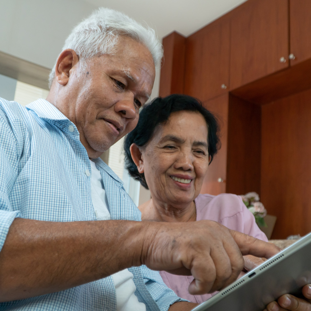 An older couple uses a tablet