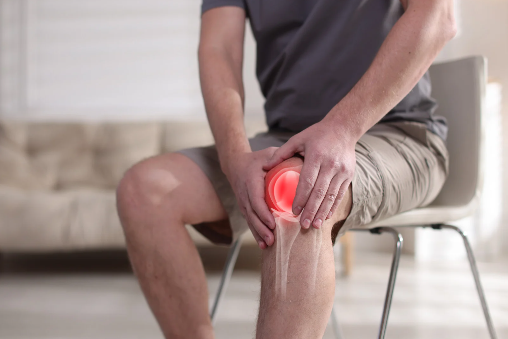 Person with knee pain sitting