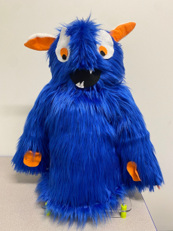 Fuzzy blue AT social robot toy.