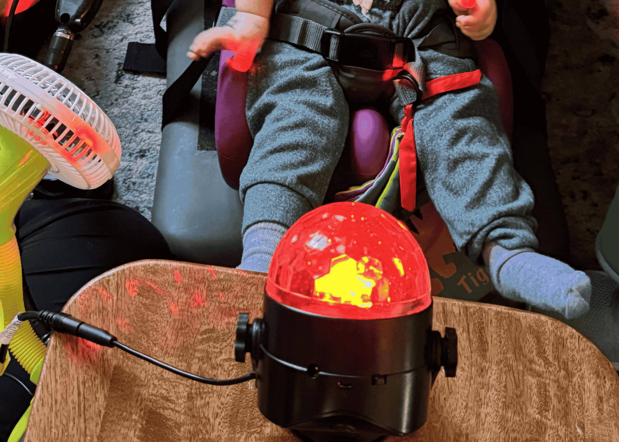 A child reaching toward a glowing dome-shaped sensory toy