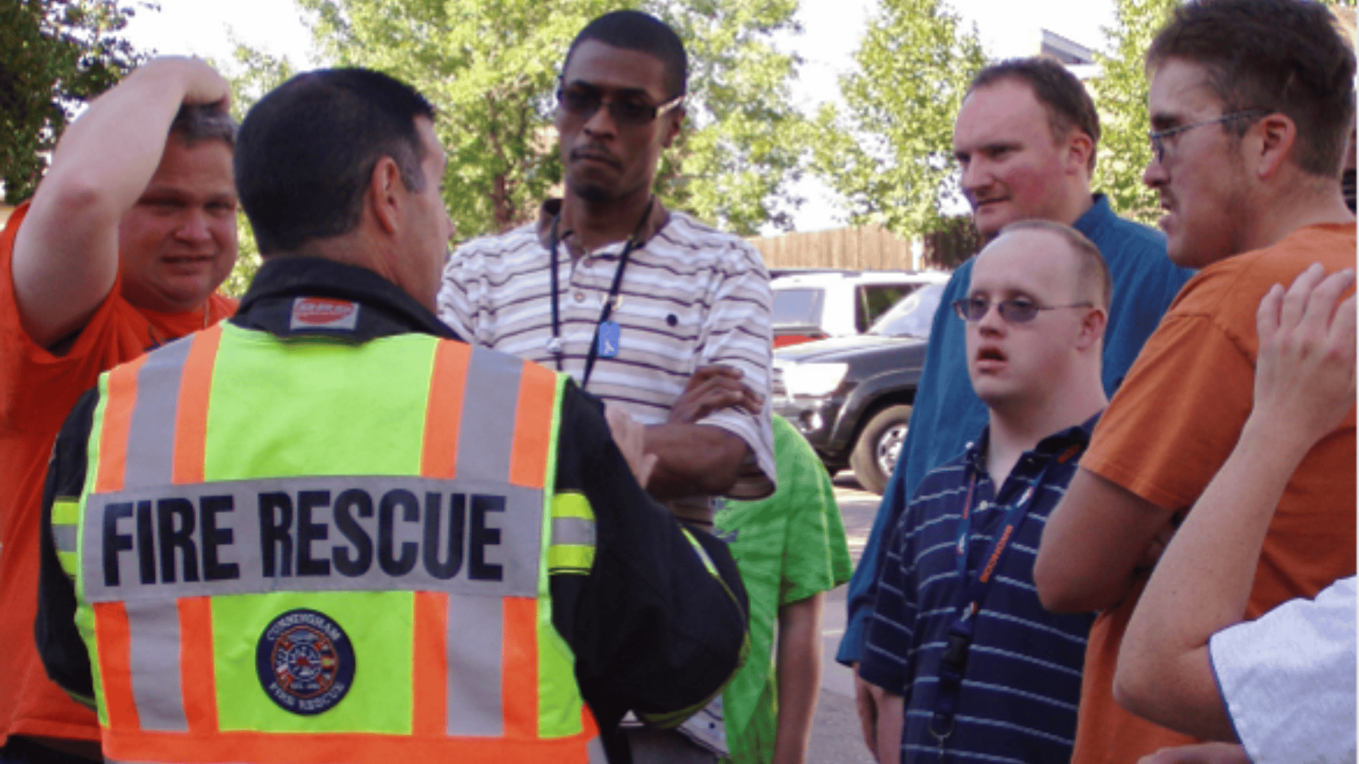 A group of participants listen to a fire rescue instructor