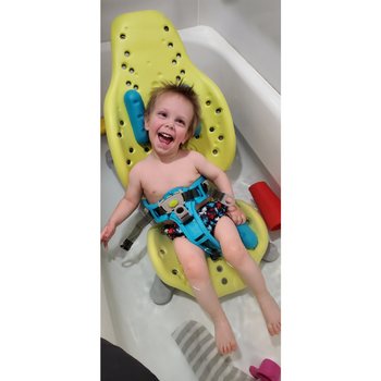 a giggling boy in a splashy bath seat in the bath