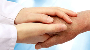 Doctor's hands holding patient's hands