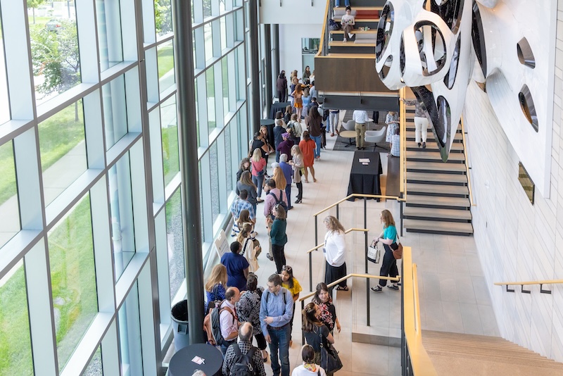 Faculty/staff and students walking around the halls of the  student center