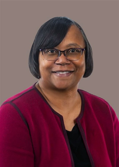 Professional headshot of Zina L. Evans, PhD wearing black blouse with burgundy sweater