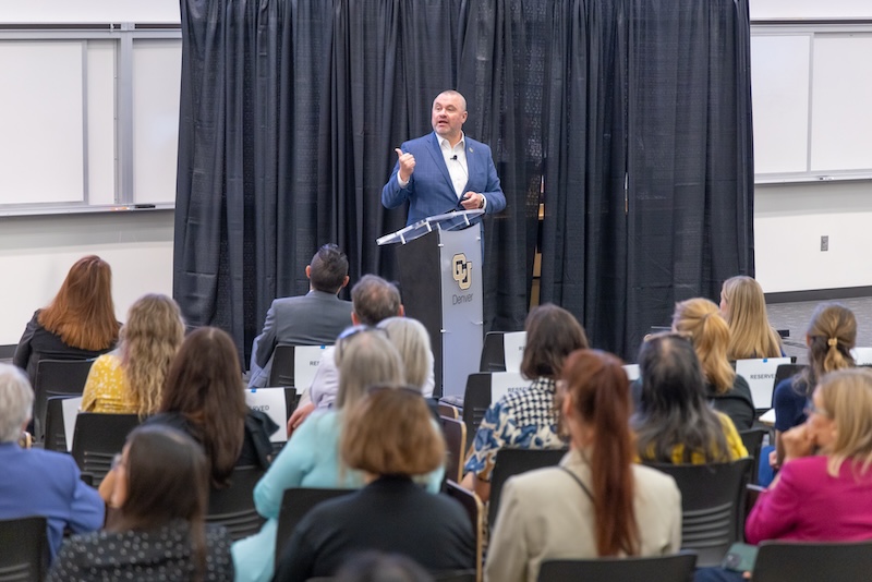 Chancellor Christensen standing at podium talking to audience