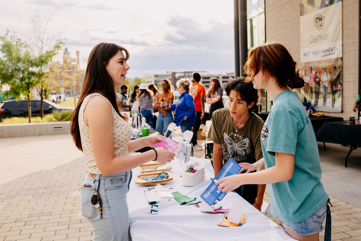 two women talking at a tabling fair